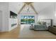 Tranquil main bedroom offering waterfront views, vaulted ceiling, and a cozy fireplace at 612 Juan Anasco Dr, Longboat Key, FL 34228