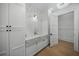 Clean mud room with white cabinets, tile walls, and a marble countertop sink at 612 Juan Anasco Dr, Longboat Key, FL 34228
