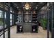 Sophisticated home office with custom shelving, decorative items, and a large desk at 612 Juan Anasco Dr, Longboat Key, FL 34228
