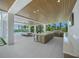 Luxury outdoor living space with a kitchen and dining area overlooking the pool and water at 612 Juan Anasco Dr, Longboat Key, FL 34228