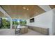Well-equipped outdoor kitchen with a bar top, stainless steel appliances, and island for seamless entertaining at 612 Juan Anasco Dr, Longboat Key, FL 34228