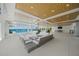Expansive covered outdoor space with modern furniture, offering a comfortable lounge area with tranquil water views at 612 Juan Anasco Dr, Longboat Key, FL 34228