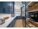 Brightly lit pantry featuring custom cabinets, quartz countertop, and storage shelving at 612 Juan Anasco Dr, Longboat Key, FL 34228
