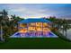 Expansive two-story home with a sprawling backyard, pool, lounge chairs, and lush tropical landscaping at 612 Juan Anasco Dr, Longboat Key, FL 34228