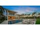 Beautiful two-story home featuring a pool, outdoor lounge area, lush greenery, and serene backyard setting at 612 Juan Anasco Dr, Longboat Key, FL 34228