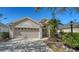 Charming home featuring a well-manicured front lawn, a two-car garage and a welcoming arched entryway at 6226 Blueflower Ct, Lakewood Ranch, FL 34202