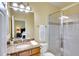 Bright bathroom boasts a granite vanity, walk in shower, and vanity lighting at 6512 Moorings Point Cir # 201, Lakewood Ranch, FL 34202