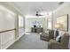 Open concept bonus room with a built-in wet bar, mini fridge, ceiling fan, and comfortable seating arrangement at 6512 Moorings Point Cir # 201, Lakewood Ranch, FL 34202