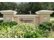 Elegant community entrance sign for The Moorings at Edgewater surrounded by lush landscaping and mature trees at 6512 Moorings Point Cir # 201, Lakewood Ranch, FL 34202
