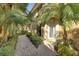 Landscaped pathway leading to the front entrance surrounded by palm trees at 6512 Moorings Point Cir # 201, Lakewood Ranch, FL 34202
