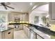 Well-lit kitchen featuring granite countertops, stainless steel appliances, and ample cabinet space at 6512 Moorings Point Cir # 201, Lakewood Ranch, FL 34202