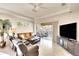 Comfortable living room area with neutral colors, large windows, and a sliding glass door to the lanai at 6512 Moorings Point Cir # 201, Lakewood Ranch, FL 34202