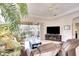 Comfortable living room with a plush sofa, entertainment center, and a screened lanai offering serene views at 6512 Moorings Point Cir # 201, Lakewood Ranch, FL 34202