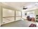 Upstairs space with ceiling fan, carpet and view of stairwell with wood railing at 6512 Moorings Point Cir # 201, Lakewood Ranch, FL 34202
