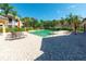 Relaxing community pool surrounded by palm trees, lounge chairs, and lush landscaping, perfect for outdoor enjoyment at 6512 Moorings Point Cir # 201, Lakewood Ranch, FL 34202