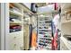 Organized walk-in closet with shelving, drawers, and rods for optimal storage at 6512 Moorings Point Cir # 201, Lakewood Ranch, FL 34202