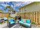 Private backyard with outdoor seating area, lush lawn, and mature trees at 6703 Midnight Pass Rd # 104, Sarasota, FL 34242