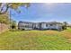 Fenced backyard with a screened-in pool area and views of the home's exterior at 6732 Keystone Dr, Sarasota, FL 34231