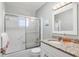 Bright bathroom featuring granite countertops, framed mirror, and glass-enclosed shower at 6732 Keystone Dr, Sarasota, FL 34231
