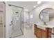 Modern bathroom with a glass-enclosed shower, a wooden vanity, and sleek fixtures at 6732 Keystone Dr, Sarasota, FL 34231