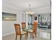 Inviting dining area featuring neutral tile flooring, fresh paint, and views to the living room at 6732 Keystone Dr, Sarasota, FL 34231