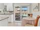 Bright kitchen featuring white cabinetry and a breakfast nook, with access to the screened-in patio at 6732 Keystone Dr, Sarasota, FL 34231