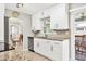 Modern kitchen featuring white cabinetry, updated appliances, neutral tones and a view to the dining room at 6732 Keystone Dr, Sarasota, FL 34231