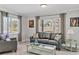 Cozy living room with a large window, comfortable seating, and neutral decor at 6732 Keystone Dr, Sarasota, FL 34231