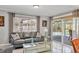 Comfortable living room with a view of the pool area, a large window, and a gray sofa at 6732 Keystone Dr, Sarasota, FL 34231