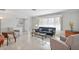 Spacious living room with neutral tile floors, fresh paint, comfortable seating, and lots of natural light at 6732 Keystone Dr, Sarasota, FL 34231