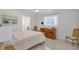 Bright main bedroom with a ceiling fan, a dresser, and an ensuite bathroom at 6732 Keystone Dr, Sarasota, FL 34231