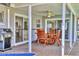 Outdoor patio with dining table, ceiling fan, and a view into the home at 6732 Keystone Dr, Sarasota, FL 34231