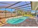 In-ground screened-in pool with landscaping, and a fenced backyard at 6732 Keystone Dr, Sarasota, FL 34231