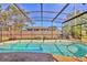 In-ground screened-in pool in a fenced backyard at 6732 Keystone Dr, Sarasota, FL 34231