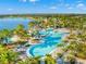 Aerial view of a resort-style pool with lake and clubhouse at 6912 Gosport Cv, Bradenton, FL 34202