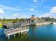 Aerial view of pier and lake house featuring waterfront views and community amenities at 6912 Gosport Cv, Bradenton, FL 34202