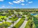 Aerial view of a gated community entrance with palm trees, landscaping, and paved roads at 6912 Gosport Cv, Bradenton, FL 34202