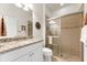 Bathroom featuring a glass-enclosed shower, granite countertop, white vanity, and a neutral color scheme at 6912 Gosport Cv, Bradenton, FL 34202