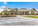 A beautiful community building featuring stone accents, tile roofing, and accessible parking at 6912 Gosport Cv, Bradenton, FL 34202