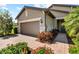 Charming single-Gathering home displaying a two-car garage, brick driveway, and well landscaped front yard at 6912 Gosport Cv, Bradenton, FL 34202