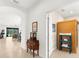 Hallway showcasing neutral walls, tile floors, and an arched doorway leading to common living area at 6912 Gosport Cv, Bradenton, FL 34202