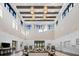 Spacious lobby with vaulted ceilings, wood beams, pendant lighting, and comfortable seating at 6912 Gosport Cv, Bradenton, FL 34202