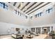 Elegant lobby with soaring ceilings, exposed wood beams, stylish seating, and ample natural light at 6912 Gosport Cv, Bradenton, FL 34202