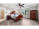 Spacious main bedroom features a wood floor, ceiling fan, and a large window at 6912 Gosport Cv, Bradenton, FL 34202