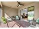 Comfortable screened patio featuring brick flooring, cozy seating, and a tranquil view of the lush backyard at 6912 Gosport Cv, Bradenton, FL 34202