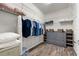 Organized walk-in closet featuring ample shelving, hanging rods, and a gray dresser, providing optimal storage at 6912 Gosport Cv, Bradenton, FL 34202