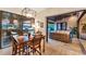 An elegant dining area with a view of the pool and outdoor seating at 7002 Dominion Ln, Lakewood Ranch, FL 34202