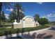 Welcoming entrance sign for the community featuring manicured hedges and paved roadway at 7002 Dominion Ln, Lakewood Ranch, FL 34202