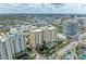 Aerial shot of condo building with water features, lush landscaping, and city views at 750 N Tamiami Trl # 814, Sarasota, FL 34236