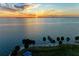 Beautiful waterfront view featuring a fishing pier, palm trees, park with pavilions, and a stunning sunset at 750 N Tamiami Trl # 814, Sarasota, FL 34236